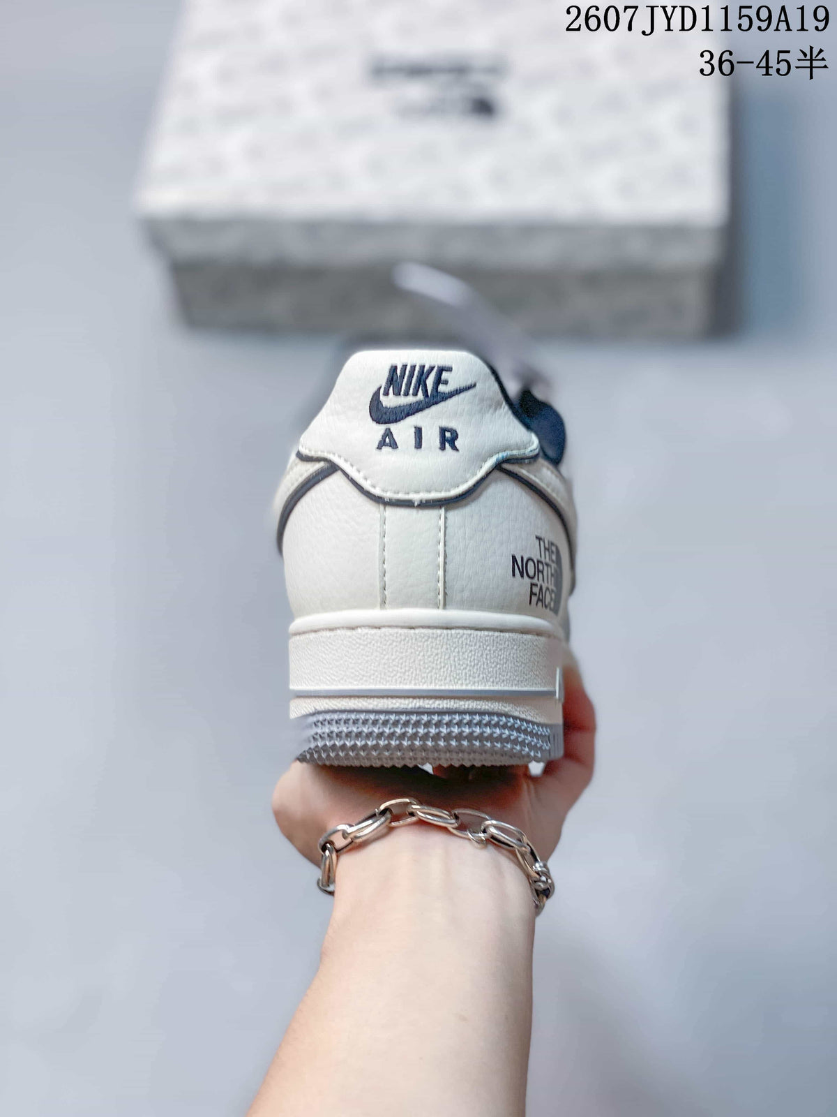 Rear view showing the Nike Air heel tab, layered heel construction, and additional The North Face marking.