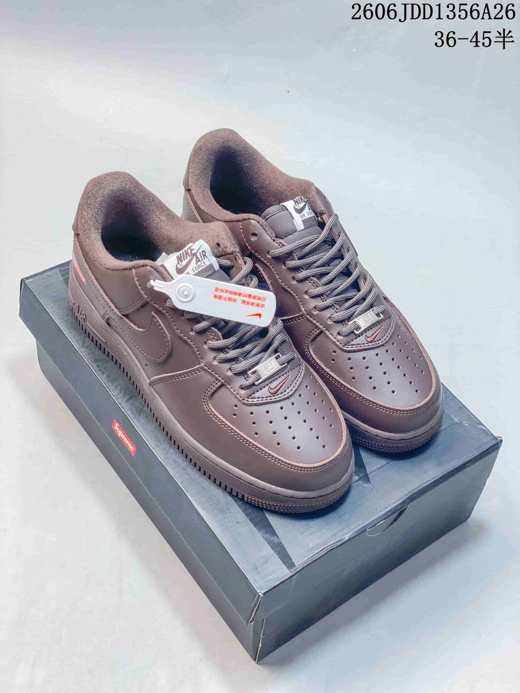Pair of brown Nike Air Force 1 '07 low-top sneakers with laces and perforated toe panels