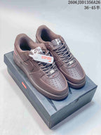 Pair of brown Nike Air Force 1 '07 low-top sneakers with laces and perforated toe panels