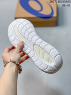 Close-up of the white rubber outsole showing the segmented tread pattern and textured traction areas.