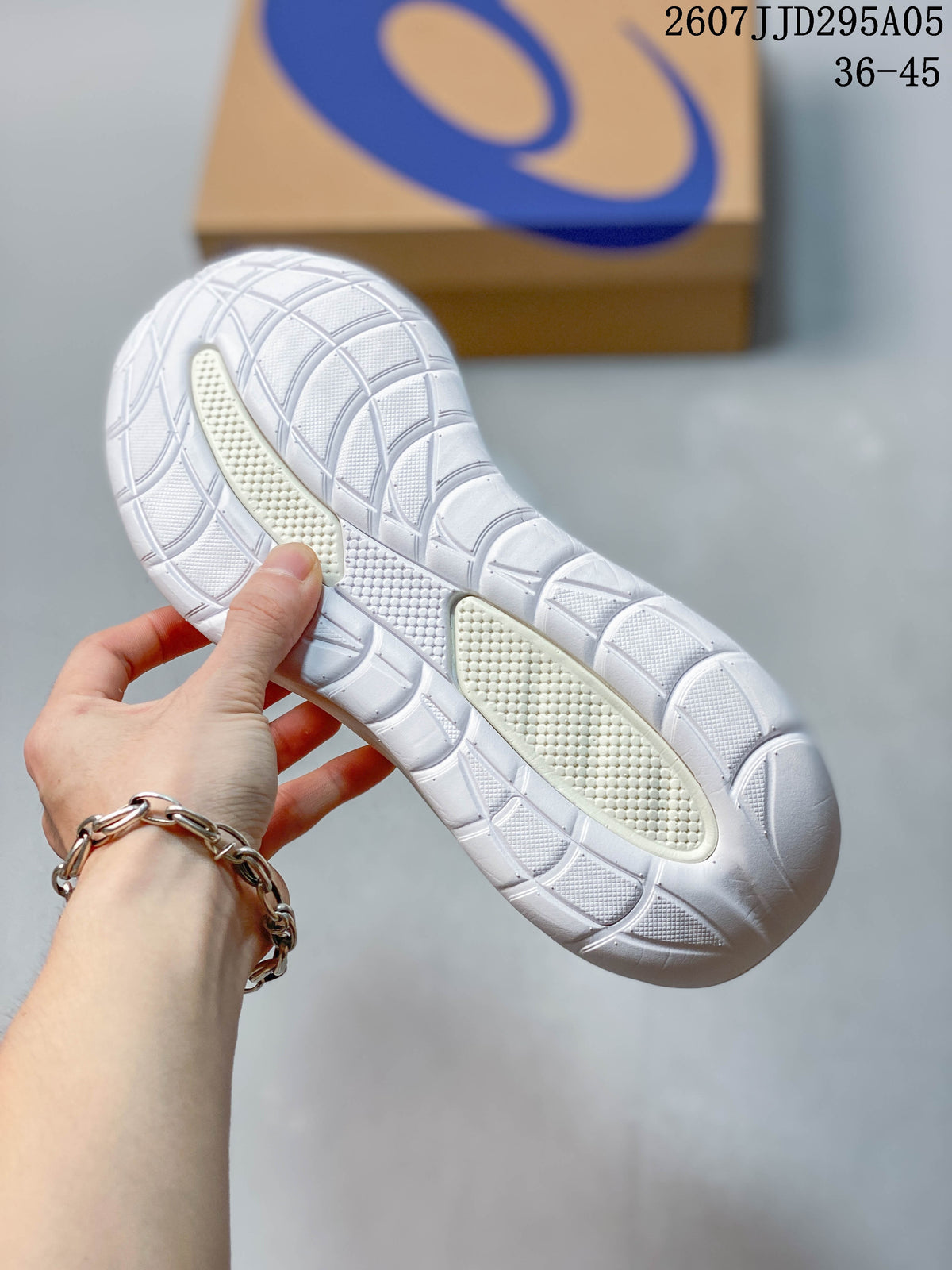 Close-up of the white rubber outsole showing the segmented tread pattern and textured traction areas.