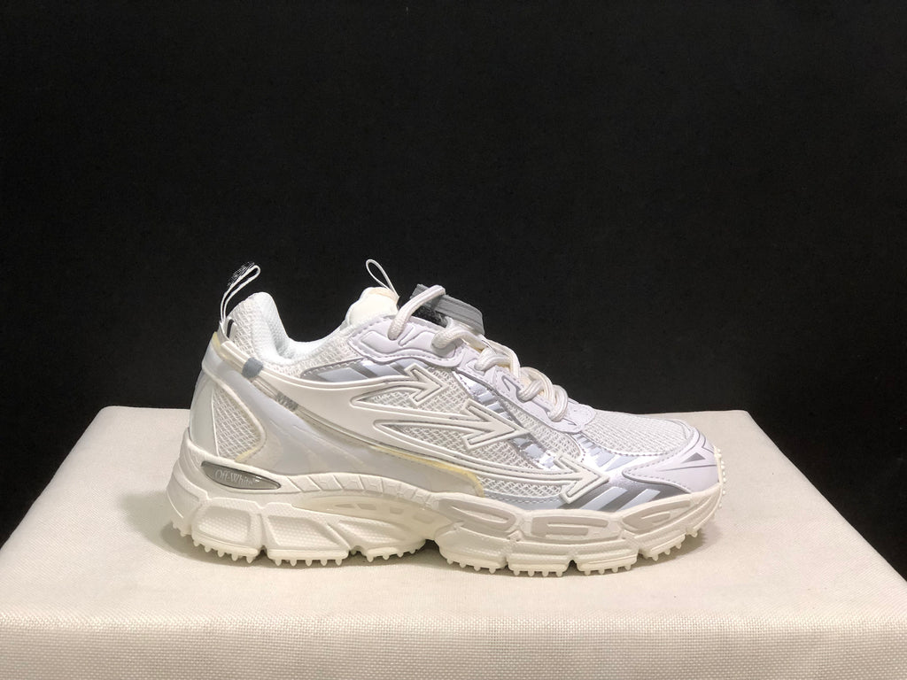 Side view of a single white Off-White sneaker highlighting the lace-up upper and textured chunky outsole.