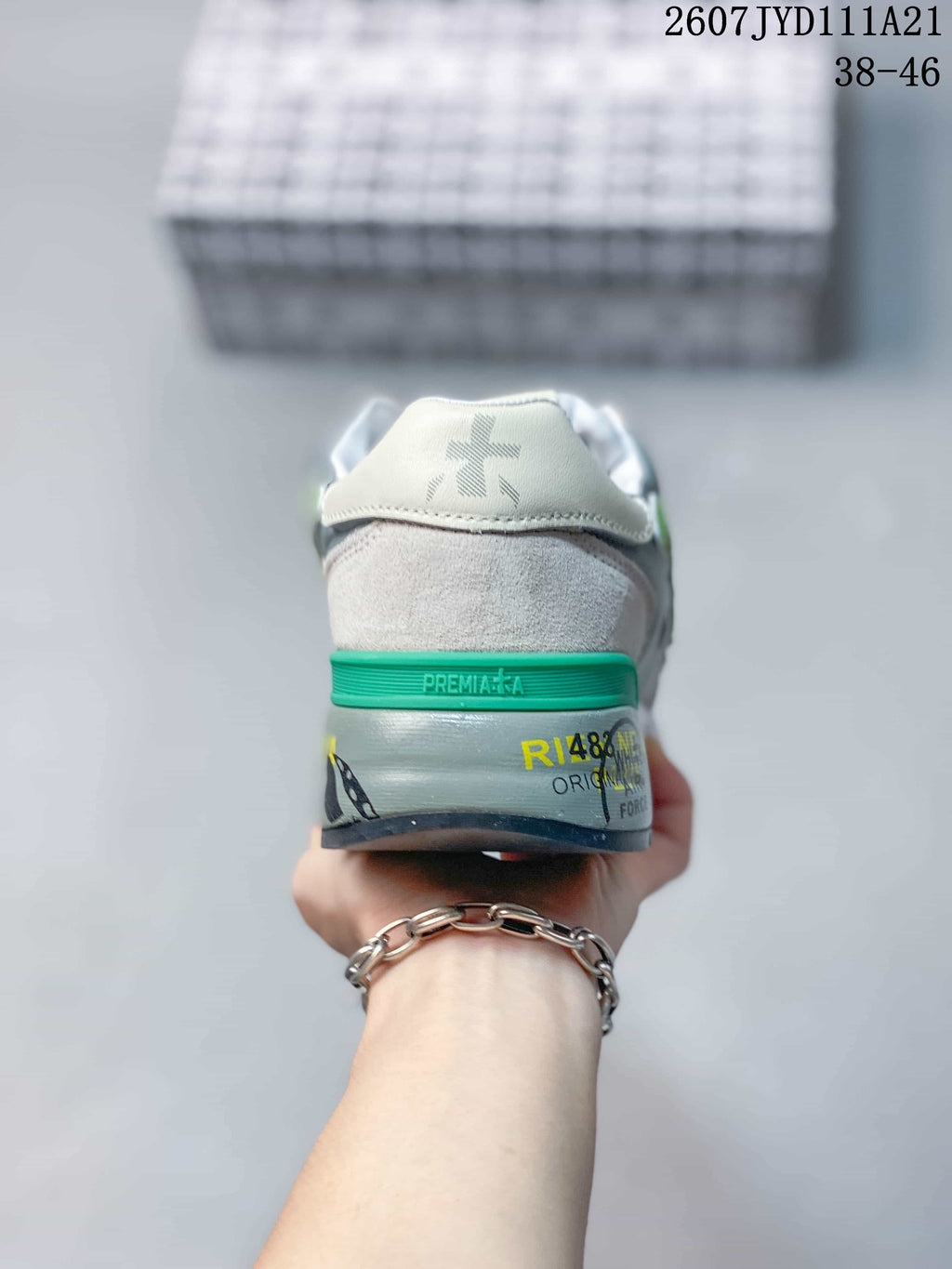 Rear view of the sneaker showing the green heel accent and printed midsole details.