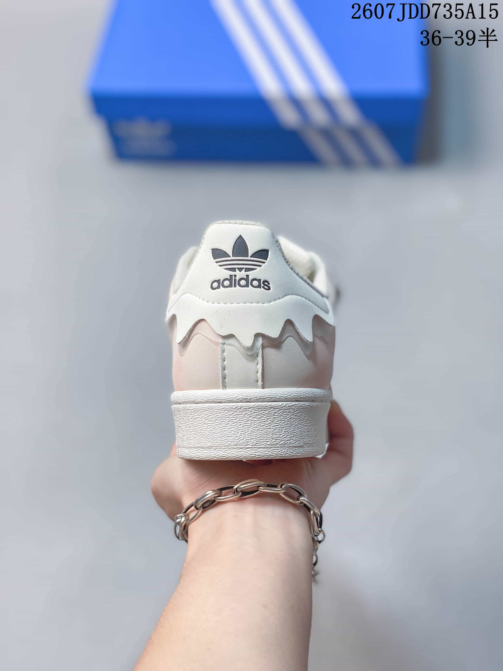 Rear view showing the adidas trefoil branding, layered heel detail, and white midsole.