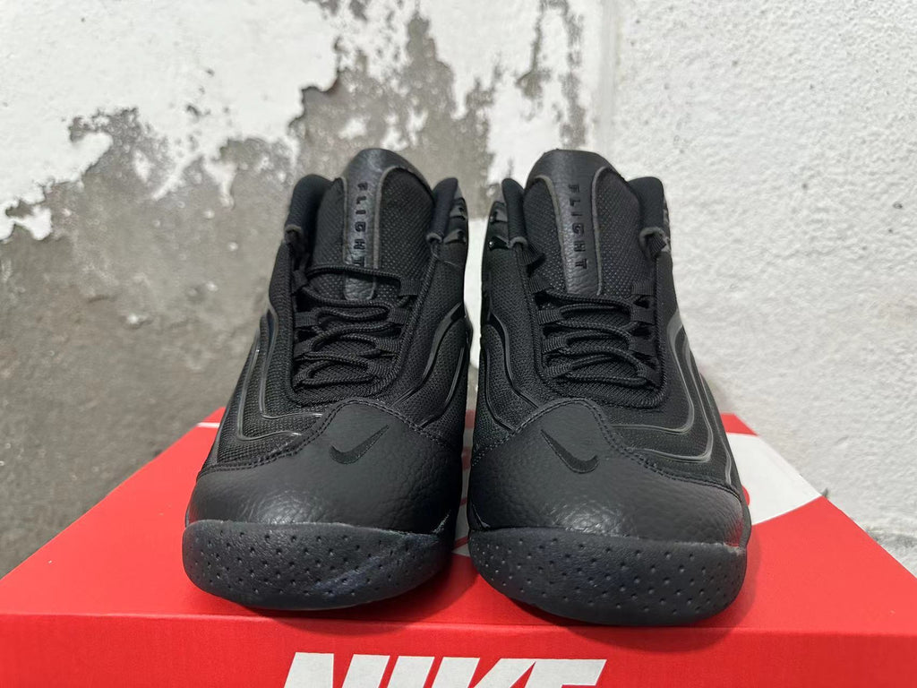Front view of black Nike high-top sneakers with laces, Swoosh details, and Flight tongue lettering.