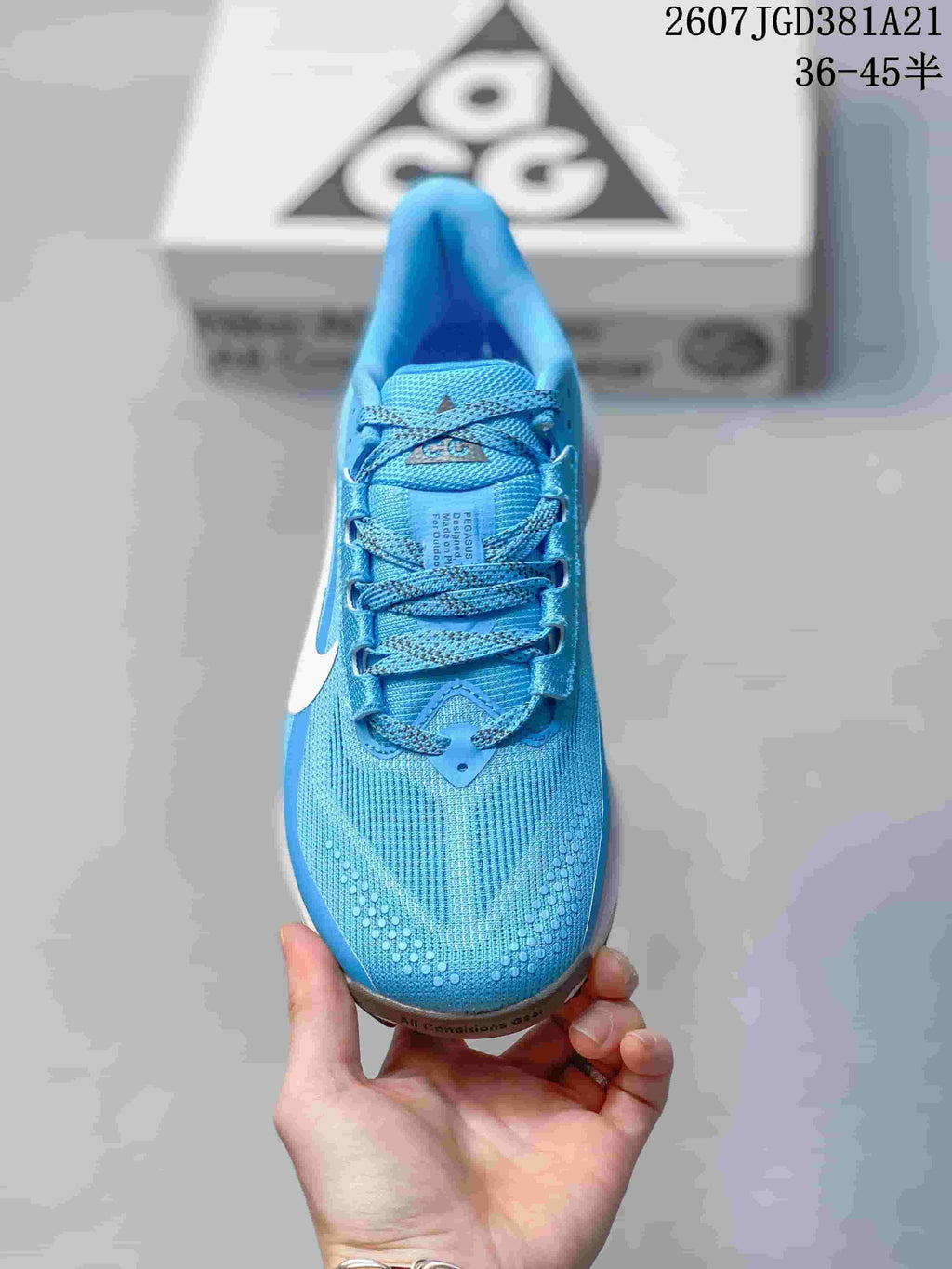 Top view of the sneaker showing the blue mesh-like upper, laces, tongue branding, and perforated toe detailing.