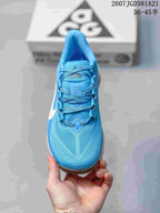 Top view of the sneaker showing the blue mesh-like upper, laces, tongue branding, and perforated toe detailing.