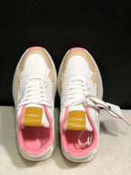 Top-down view showing the lace-up construction, textured white panels, beige overlays, pink lining and branded tongues.