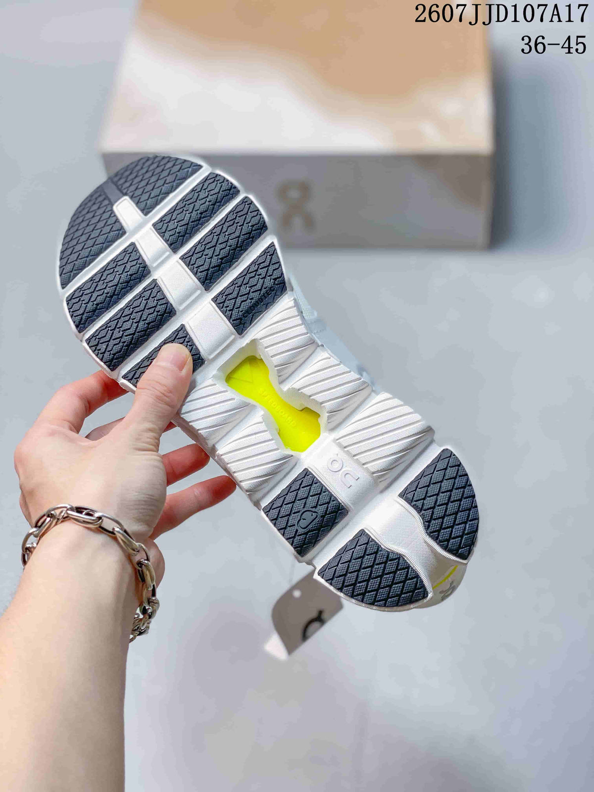 Bottom view of the sneaker showing a segmented white outsole, dark traction sections, and a central lime-colored opening.