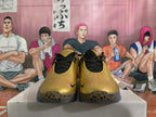 Front view of metallic gold Nike basketball shoes with black laces and spotted outsoles