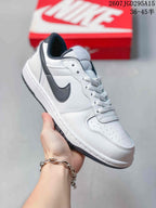 Angled side view showing the white low-top sneaker, black side branding, layered panels and contrasting outsole.