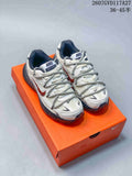 Pair of beige and off-white Nike Initiator sneakers shown from the front on an orange shoebox; image text shows style code 2607GVD117A27 and size range 36–45.5.