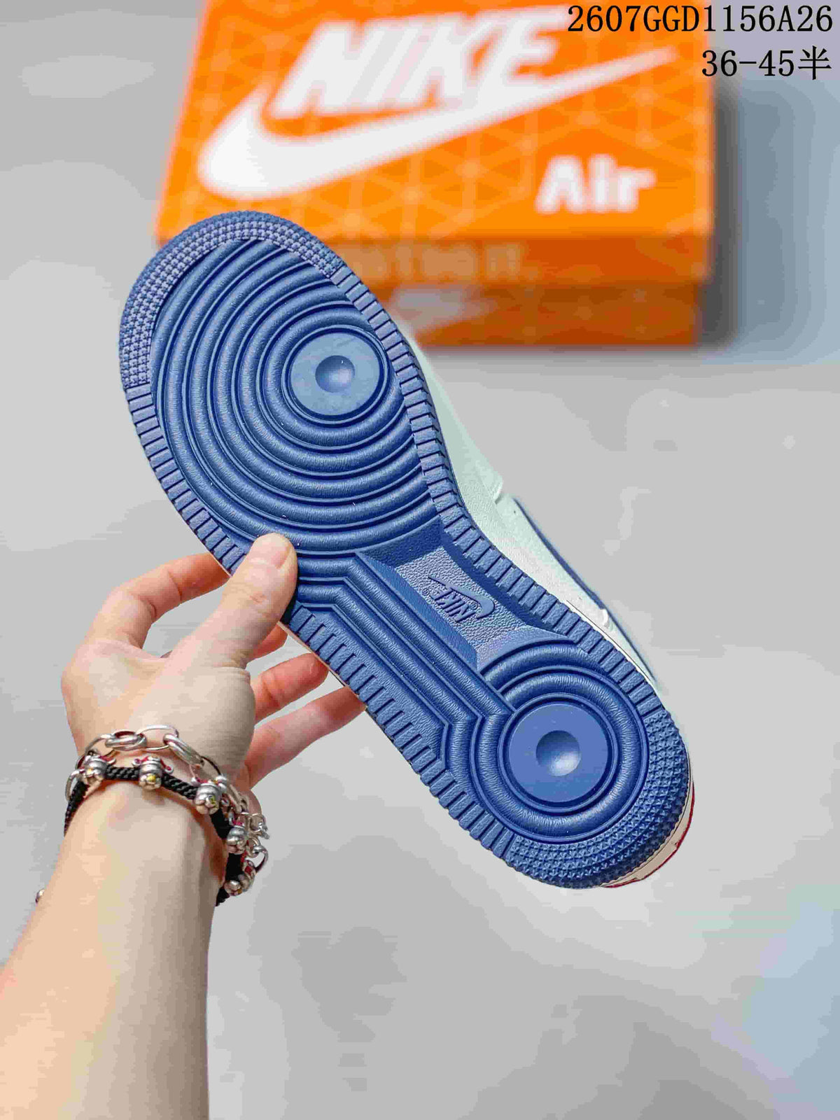 Close-up of the blue circular-pattern rubber outsole and orange shoebox.