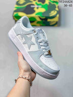 White low-top sneaker with pale gray star side graphic, white laces and white sole; source overlay shows style code 2607NY244A24 and size range 36–45.