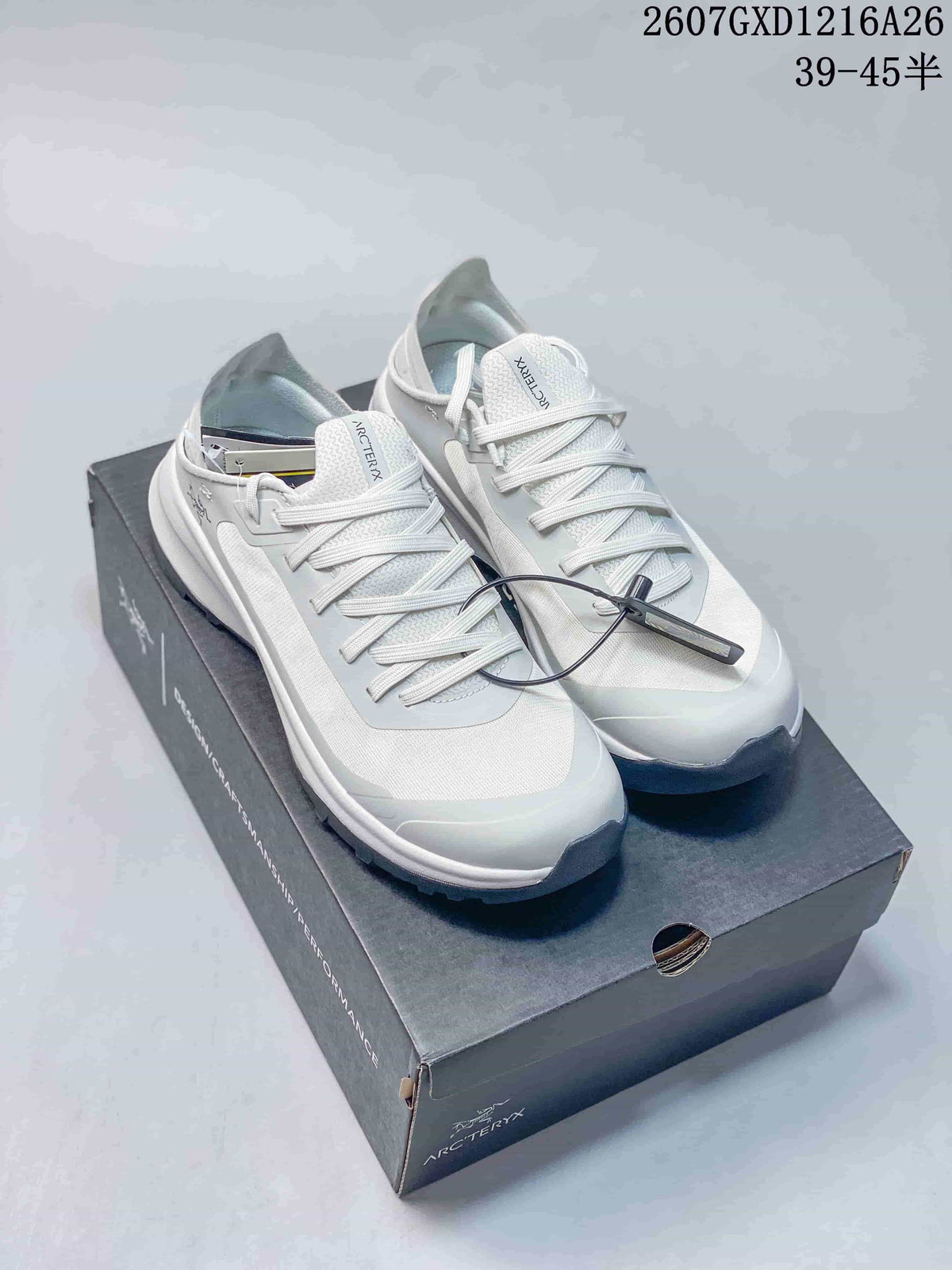 Pair of white Arc'teryx Sylan sneakers displayed on a branded shoebox, with the style reference 2607GXD1216A26 and size text visible above.