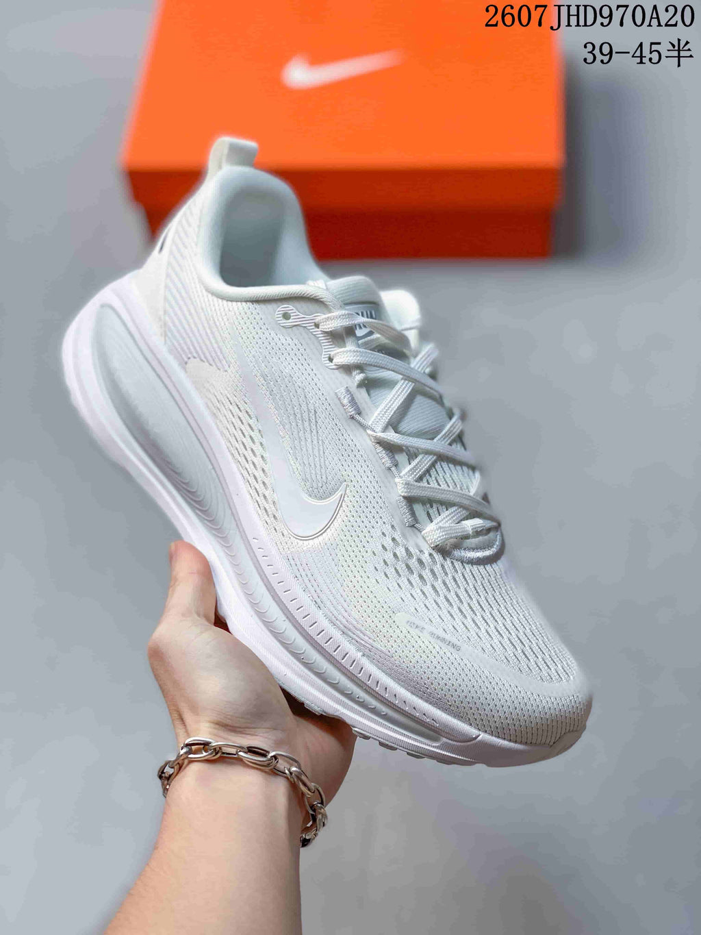 White Nike Structure Plus running sneaker with subtle light detailing and an all-white midsole.