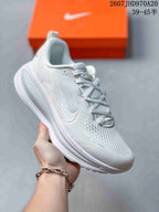 White Nike Structure Plus running sneaker with subtle light detailing and an all-white midsole.