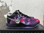 Side view showing the silver Swoosh, patterned purple and red upper, and purple outsole
