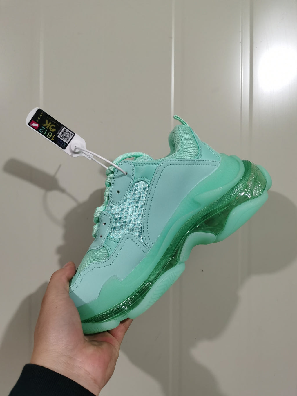 Rear-side view of the mint green Balenciaga sneaker highlighting the clear sole sections and tonal overlays.