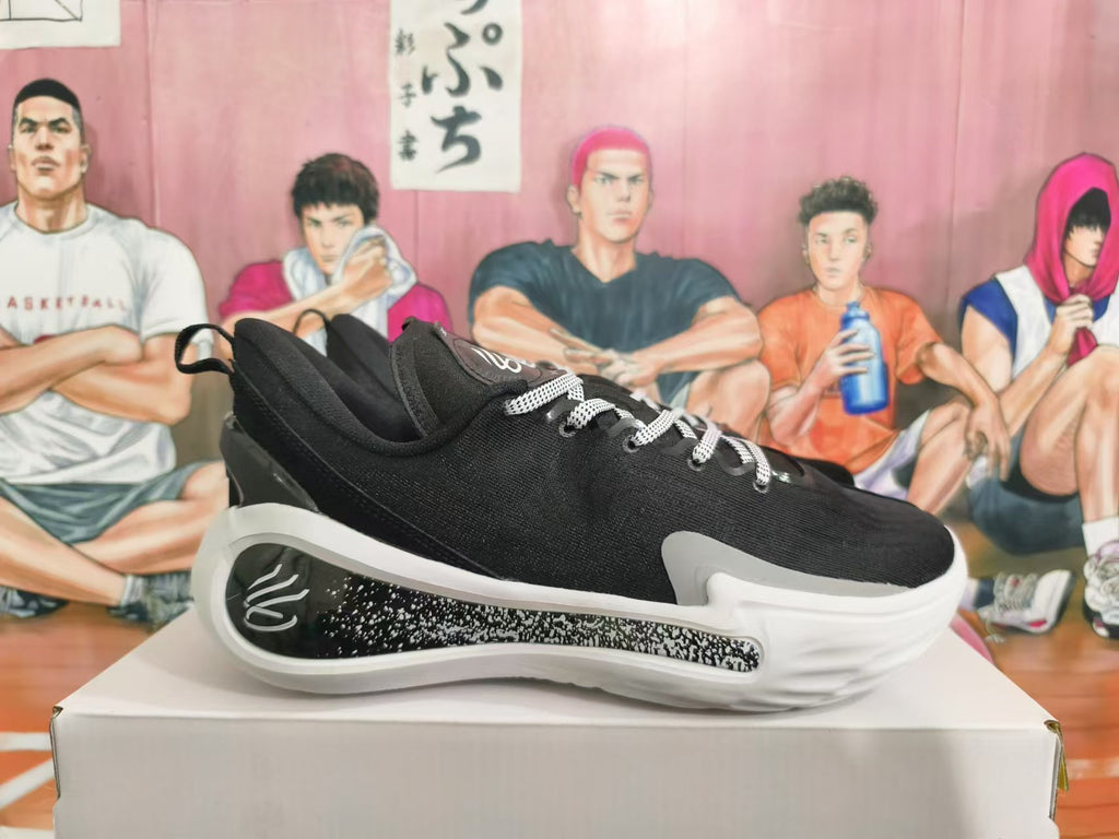 Side view of a black low-top basketball sneaker with a speckled midsole detail.