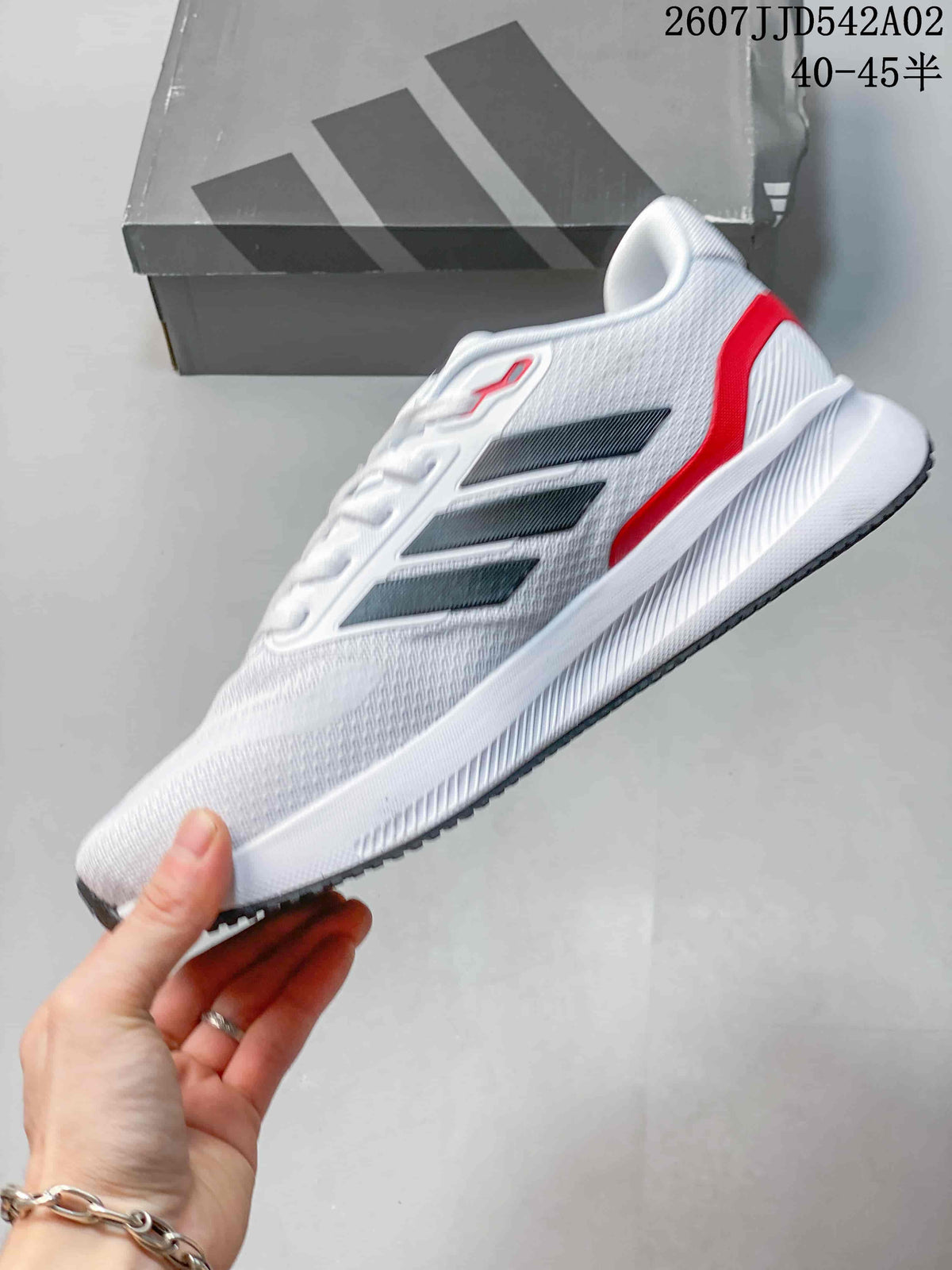 Side profile of the white Adidas Runfalcon 5 with black stripes and red heel accent.