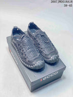 Dark gray ECCO outdoor sneakers displayed on an ECCO shoe box, showing the perforated upper and rugged outsole.