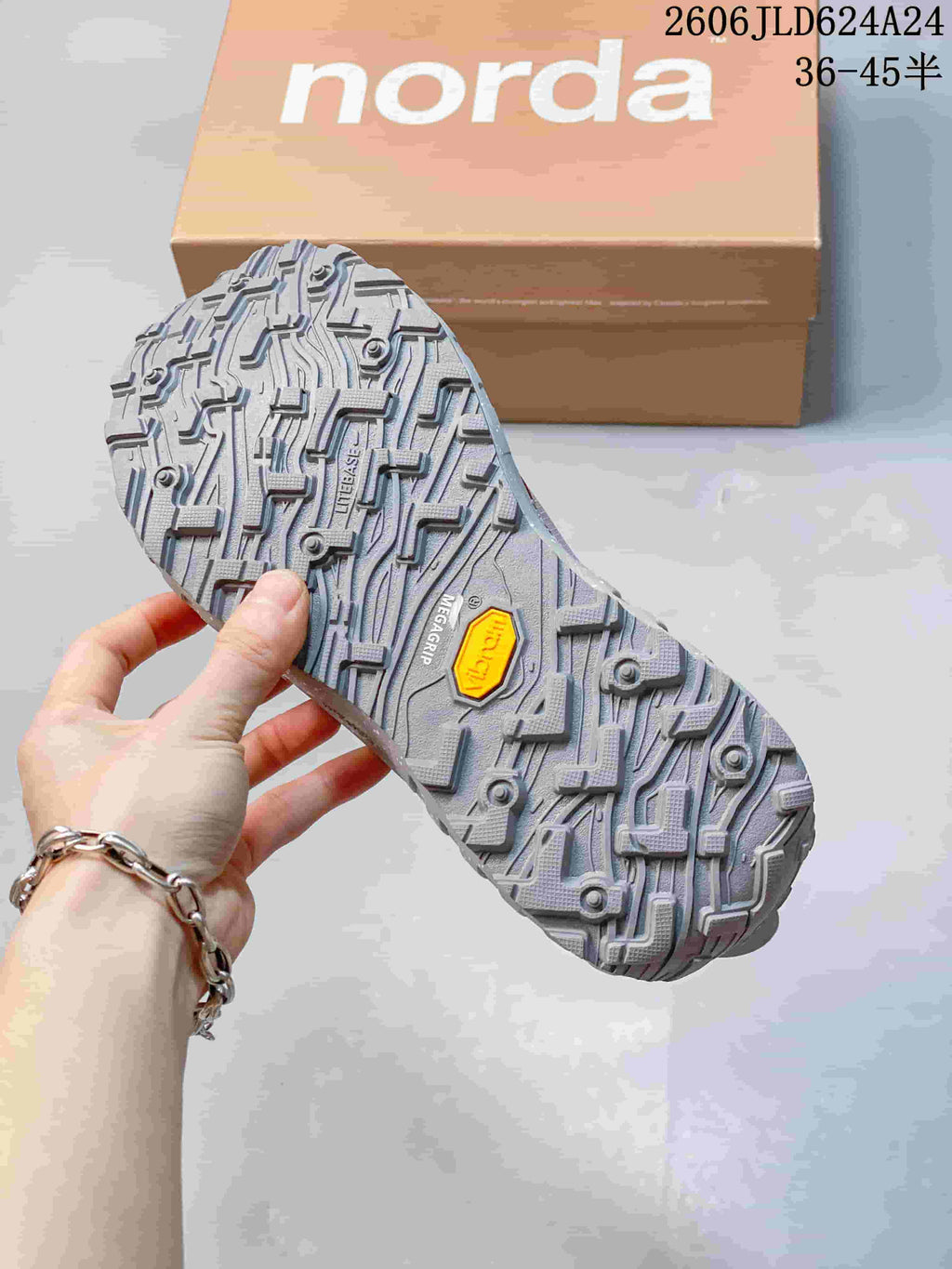 Close-up of the gray patterned outsole with a yellow Vibram badge