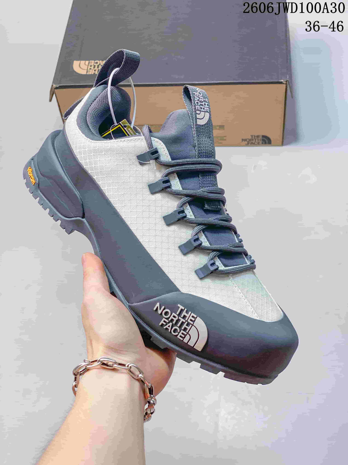 White and gray low-top The North Face Glenclyffe shoe shown from the side.