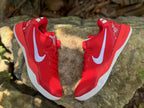 Overhead view of a pair of red Nike Kobe 8 shoes showing the white side logos