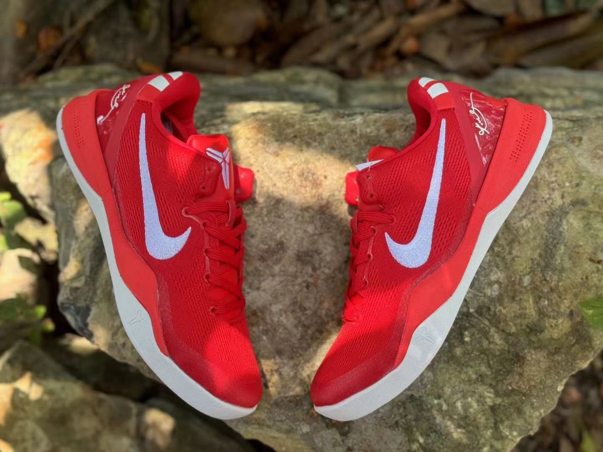 Overhead view of a pair of red Nike Kobe 8 shoes showing the white side logos