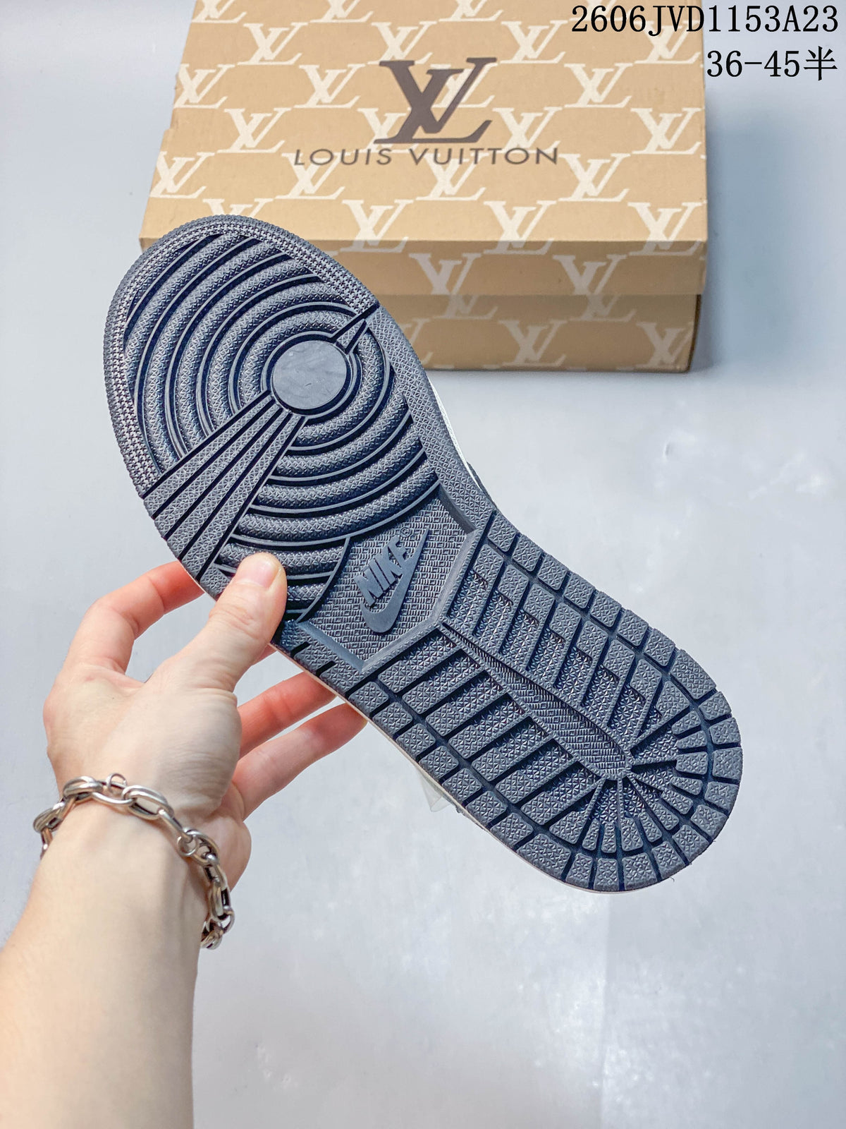 Close-up of the dark outsole tread on a blue patterned low-top sneaker.