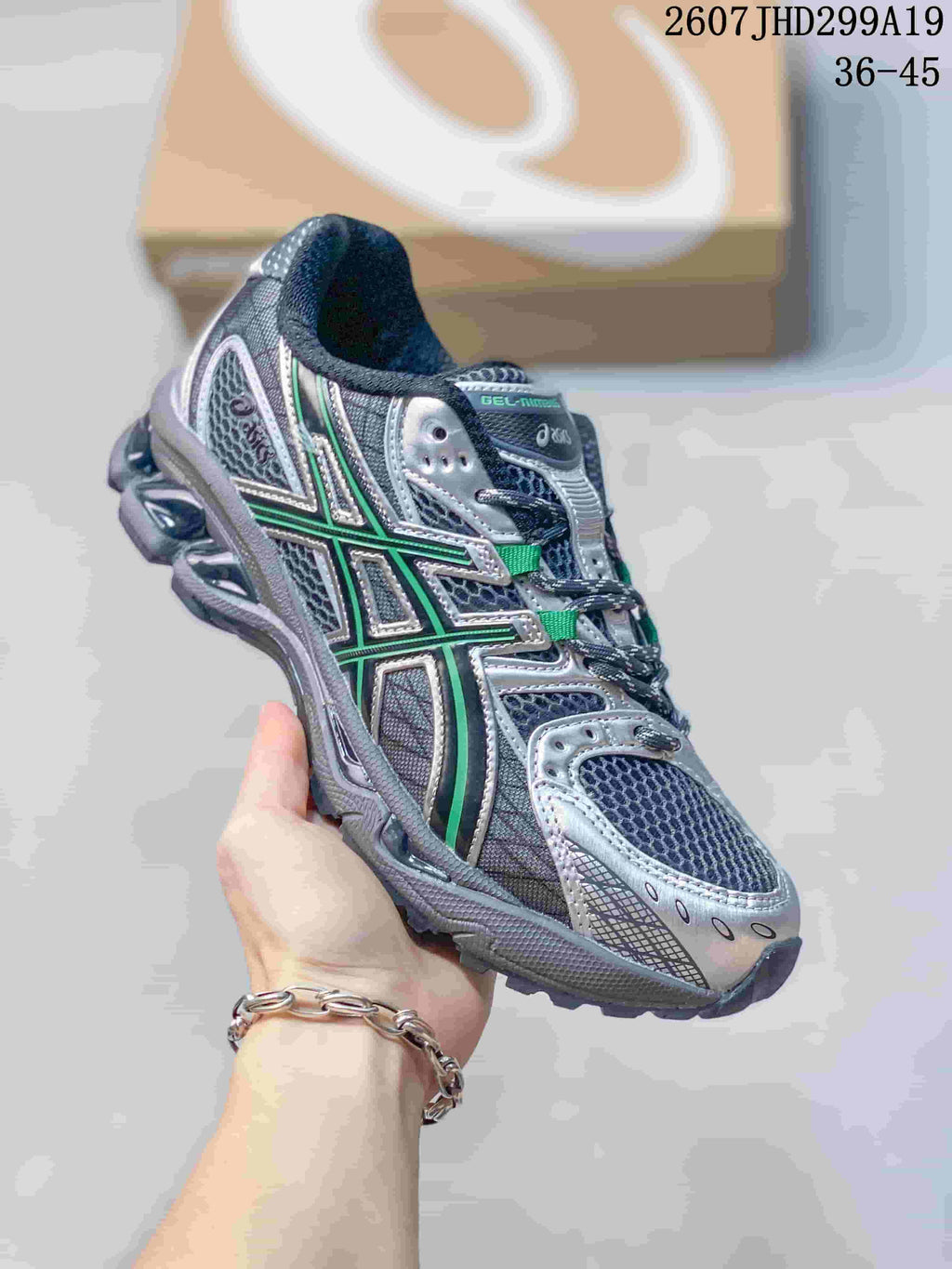 Angled front-side view showing the silver, dark gray and green upper and layered outsole.
