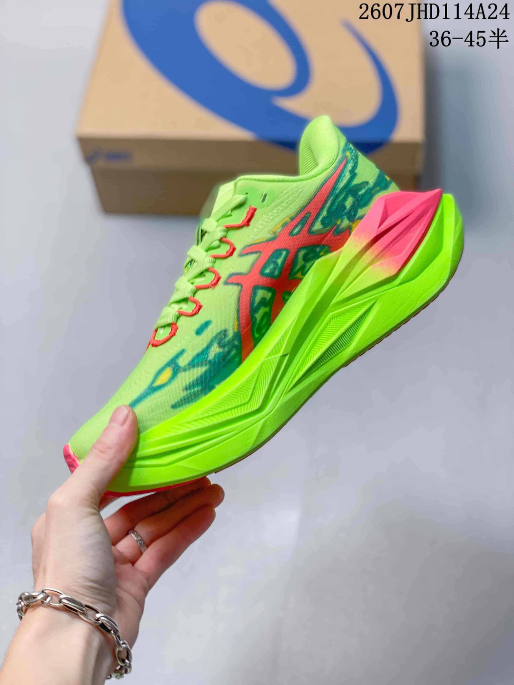 Side profile highlighting the lime green upper, red and blue graphics, and pink midsole section.
