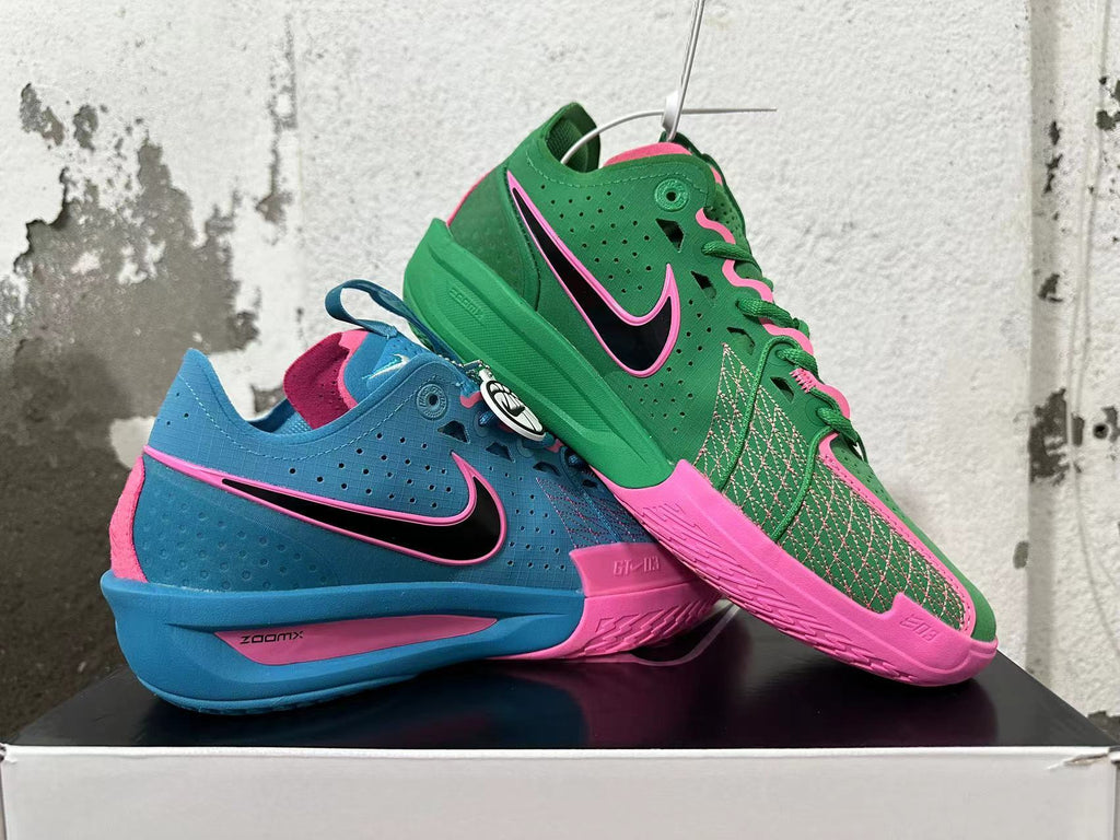 Mismatched blue-and-pink and green-and-pink Nike basketball shoes shown together