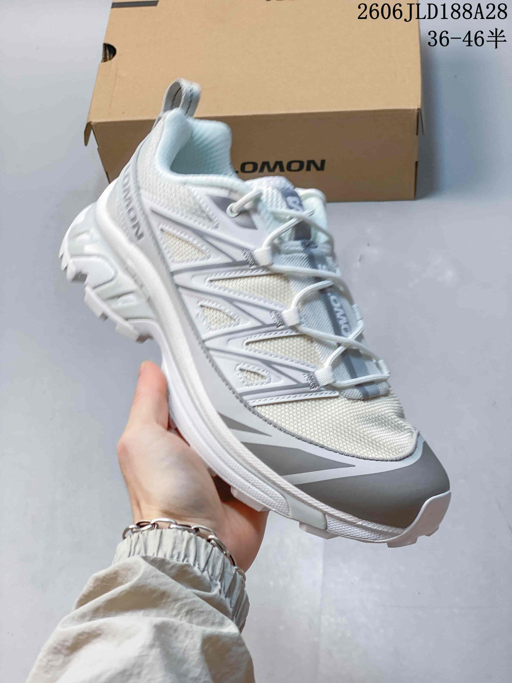 Angled view of the white and grey Salomon shoe