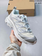 Angled view of the white and grey Salomon shoe