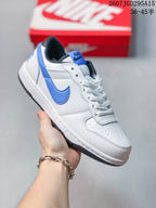 Angled side view showing the white and blue low-top sneaker with a black padded collar.