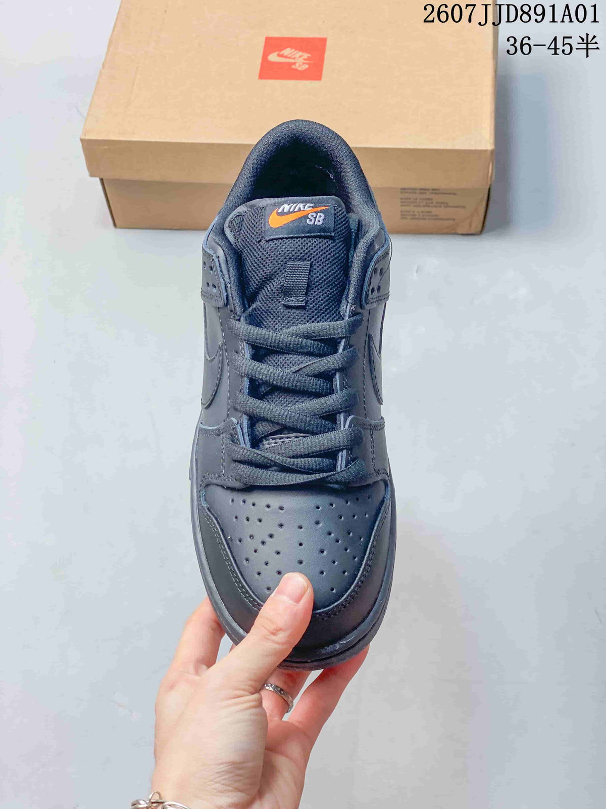 Front view of a dark gray Nike Dunk Low sneaker with perforated toe