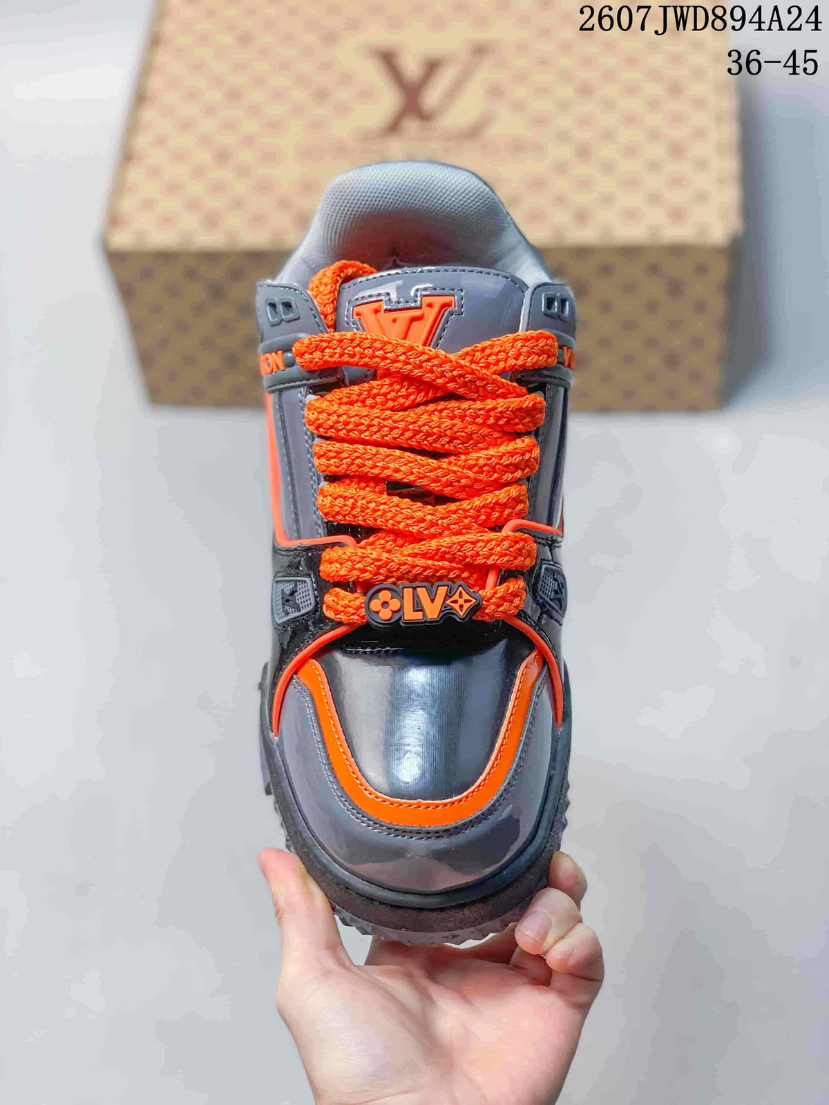 Top view showing the rounded toe, bright orange laces, gray panels, and Louis Vuitton branding.