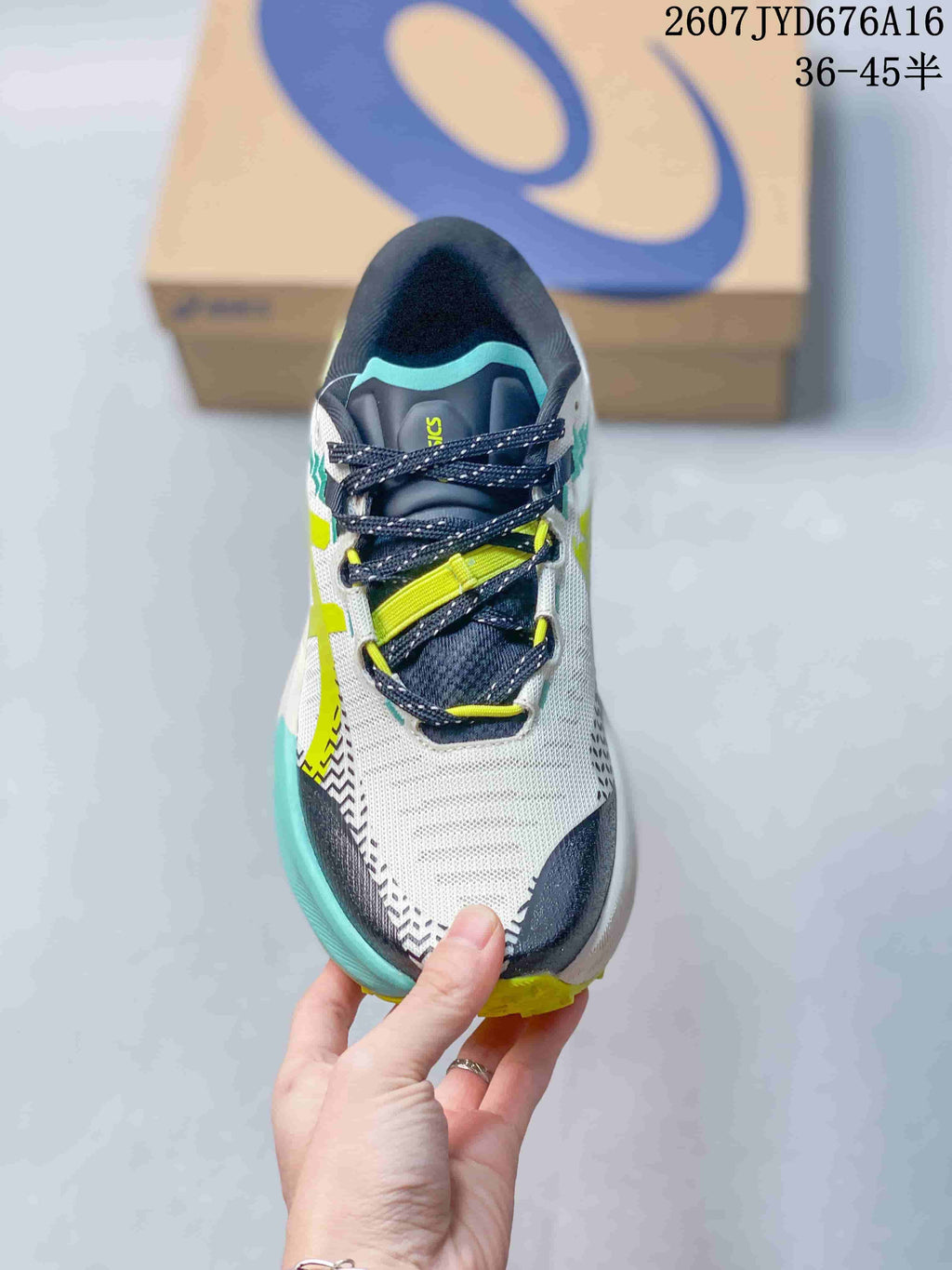 Top view of the shoe showing the navy tongue, dark laces, lime lace details, and white mesh-like upper.
