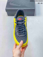 Top view of the yellow and black Nike Air Max 90 sneaker showing the dark laces, padded tongue, and textured toe panel.