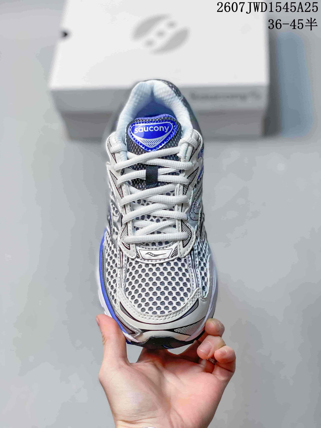 Top view of the sneaker showing the white laces, blue tongue label and patterned toe area.