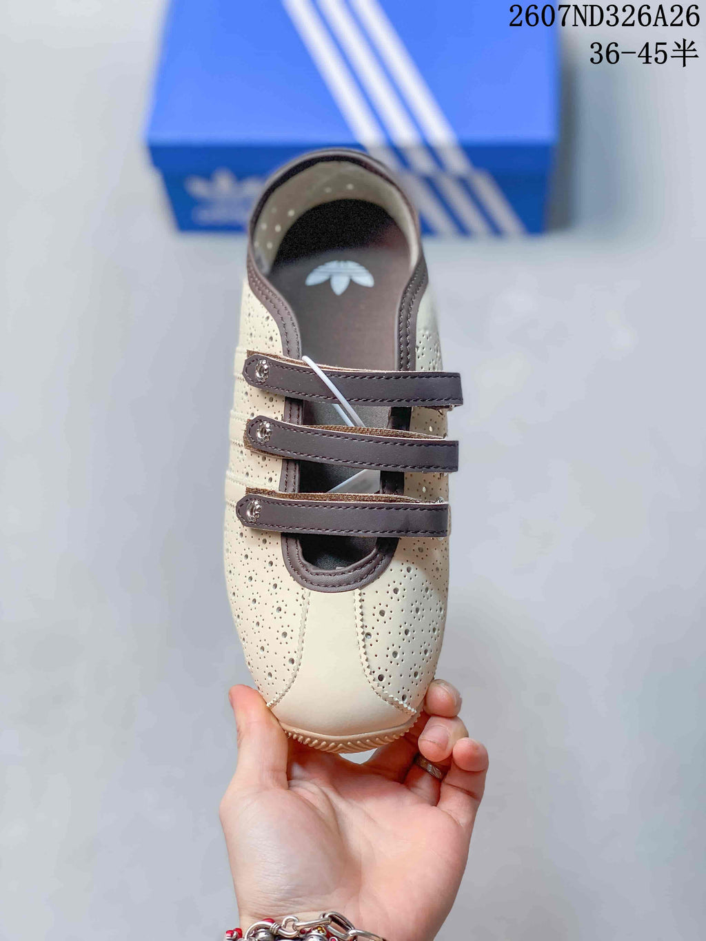 Top view showing the rounded toe, perforated panels and three brown straps.