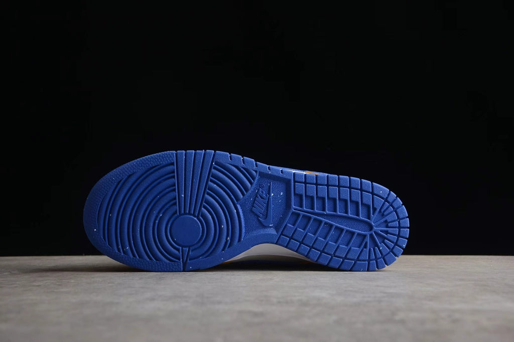 Blue rubber outsole shown from below with circular forefoot and segmented tread patterns.