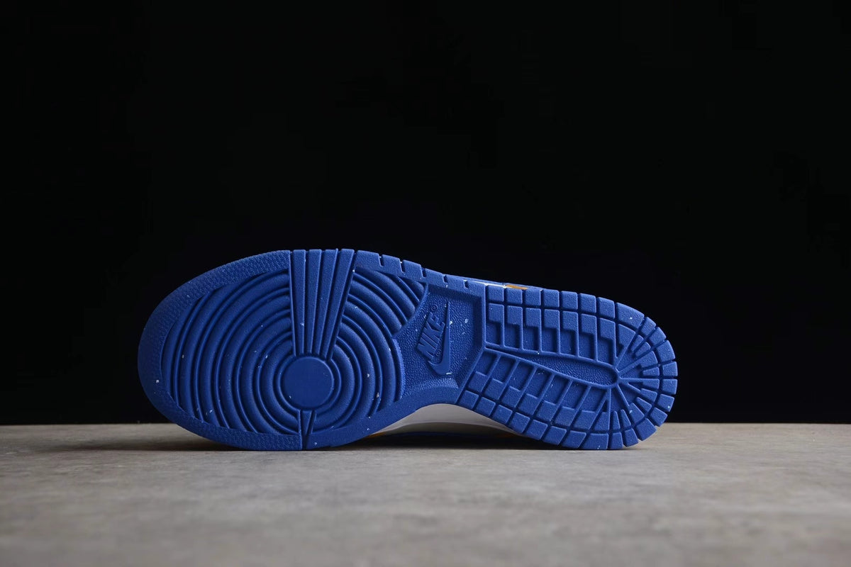 Blue rubber outsole shown from below with circular forefoot and segmented tread patterns.