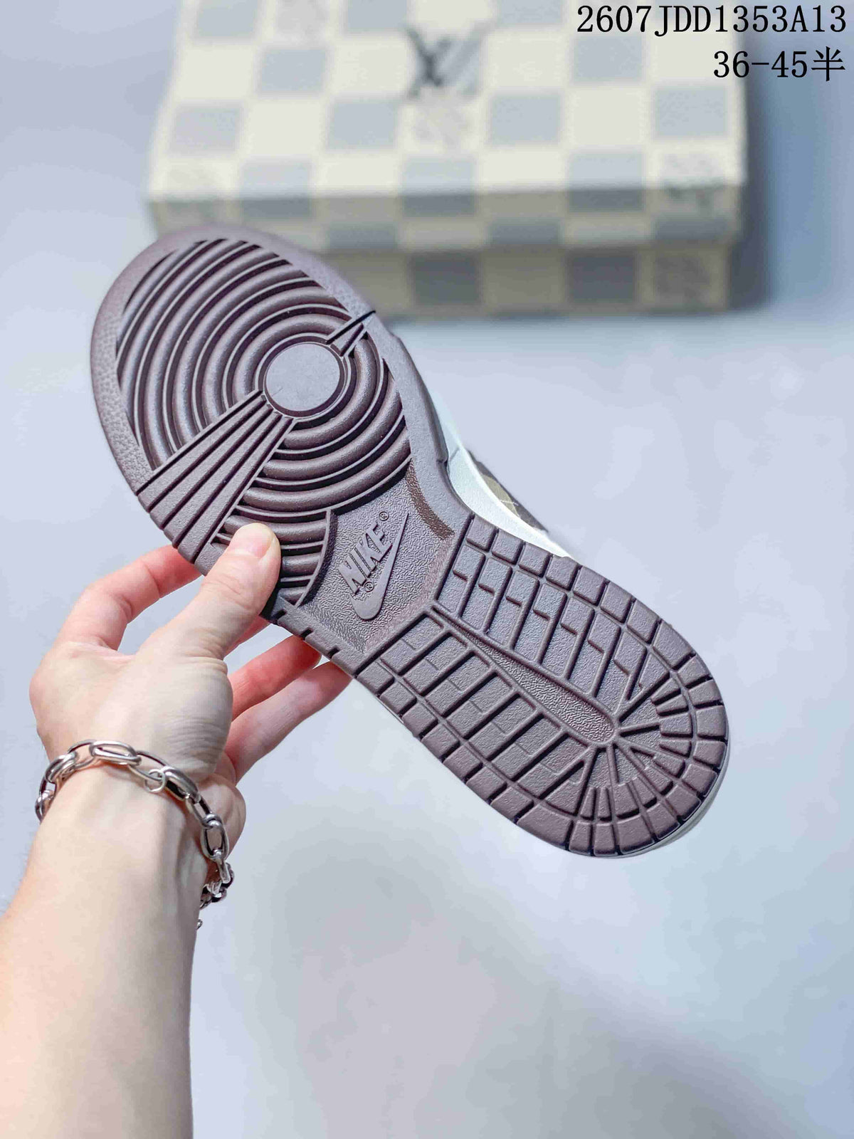Underside view showing the brown textured rubber outsole and circular forefoot tread.