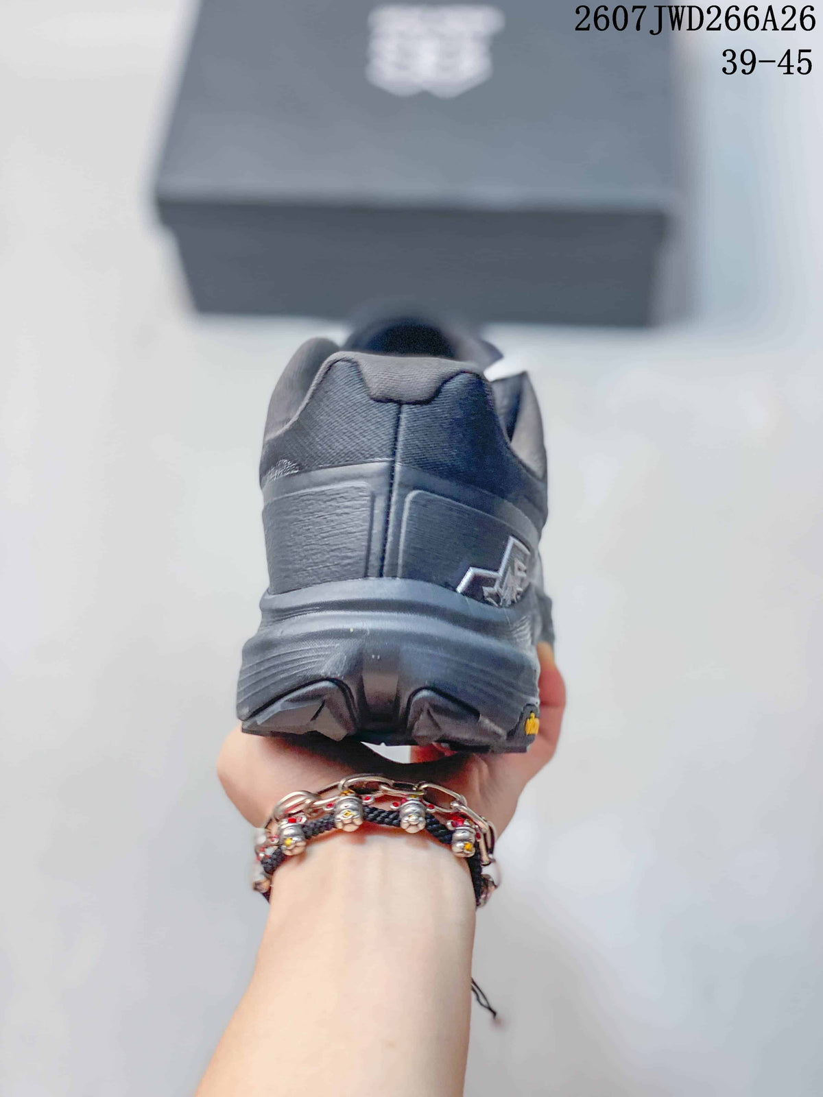 Rear view of a dark KRUST trail running shoe showing the heel construction, layered outsole, and visible branding details.