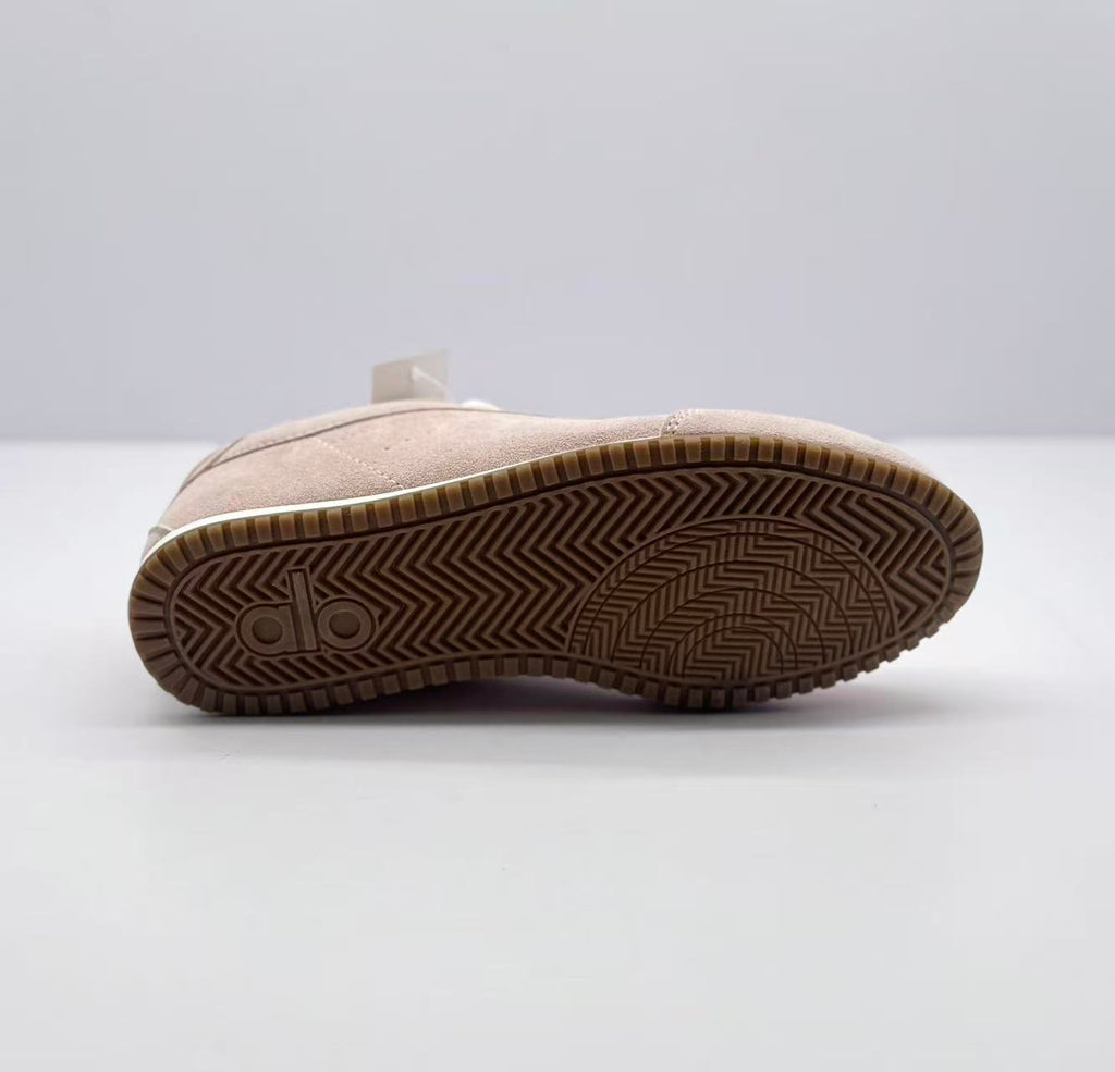 Underside view showing the brown rubber outsole and patterned tread.