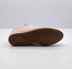 Underside view showing the brown rubber outsole and patterned tread.