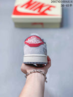 Rear view showing the gray heel panel, red embroidered heel detail, white midsole, and gray outsole.